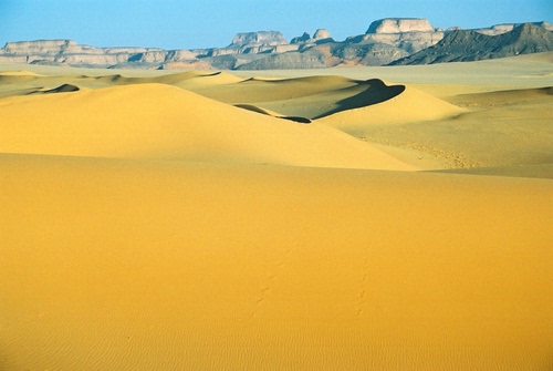 Immagine con sabbia, dune, deserto, giallo, cielo, panorama, azzurro, montagne, rocce, montagna, ombre