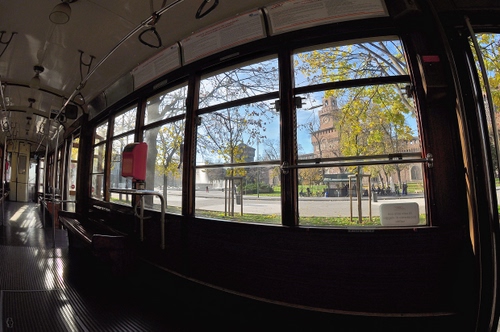 Immagine con tram, castello, finestrini, milano, alberi, torre, maniglie, vetro