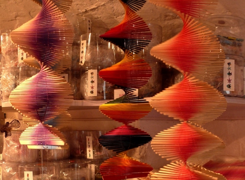 Immagine con rosso, spirali, spirale, vetrina, colori, nero, bicchieri, legno, tre, girandole