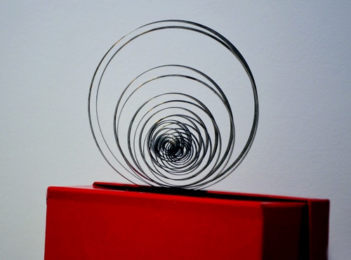 Immagine con rosso, spirale, scatola, molla, curve, acciaio, cerchi