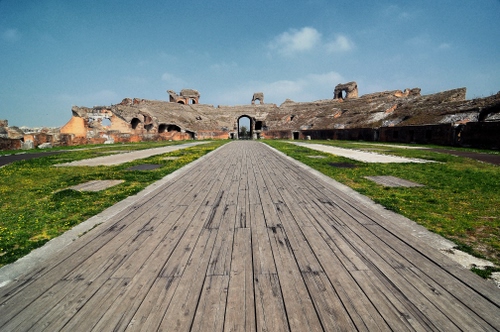 Immagine con cielo, legno, prato, erba, verde, strada, passerella, anfiteatro, ruderi, nuvole, arco, rovine, arena, teatro, prospettiva, rudere, archi, tavole, assi